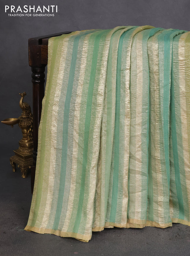 Munga silk saree green shade with allover zari woven stripes pattern in borderless style