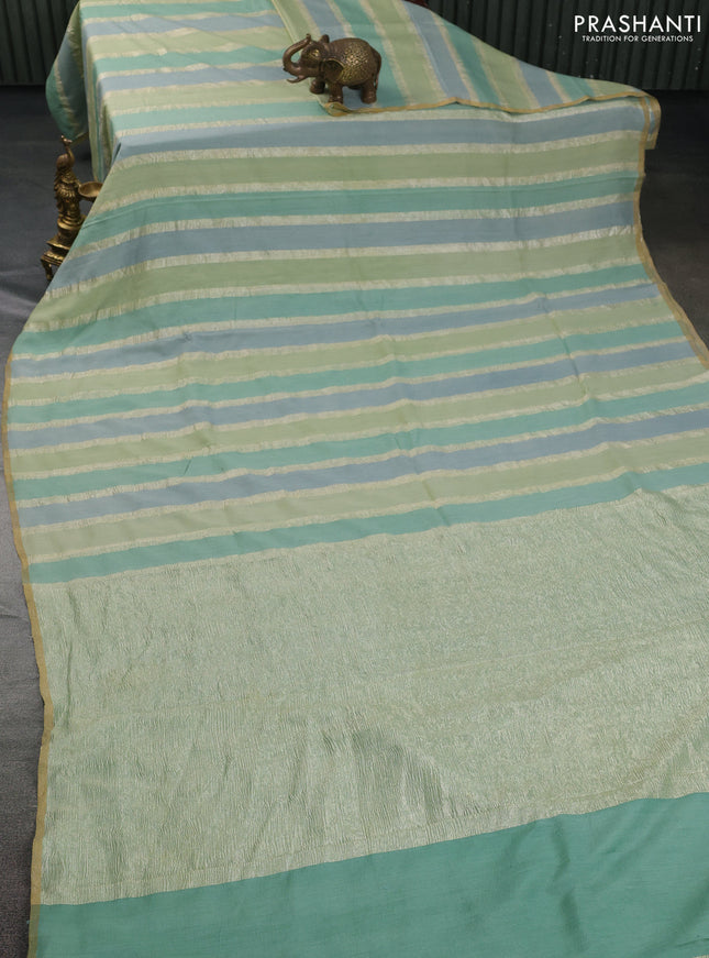 Munga silk saree pastel green and pastel blue with allover zari woven stripes pattern in borderless style