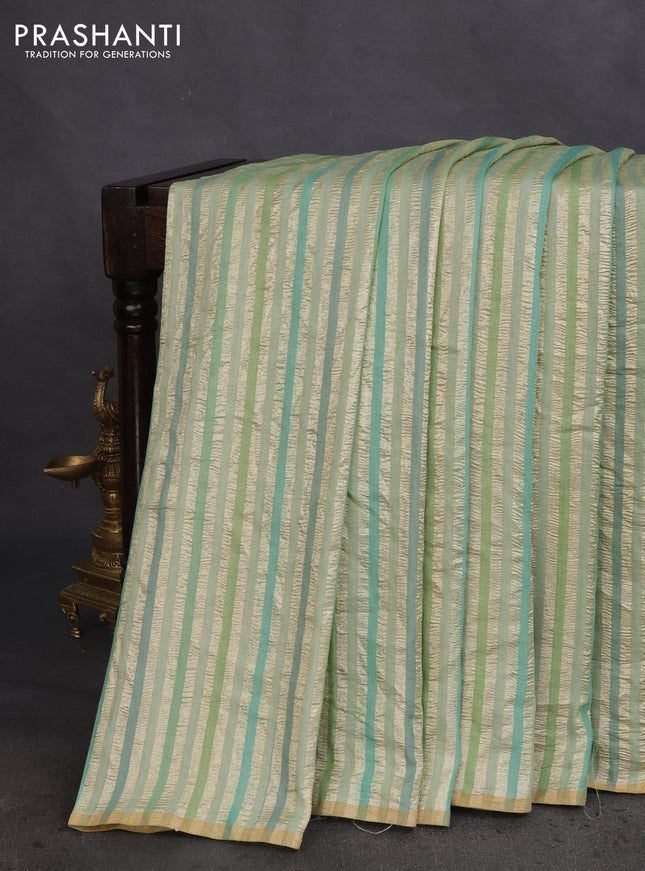 Munga silk saree pastel green with allover zari woven stripes pattern in borderless style