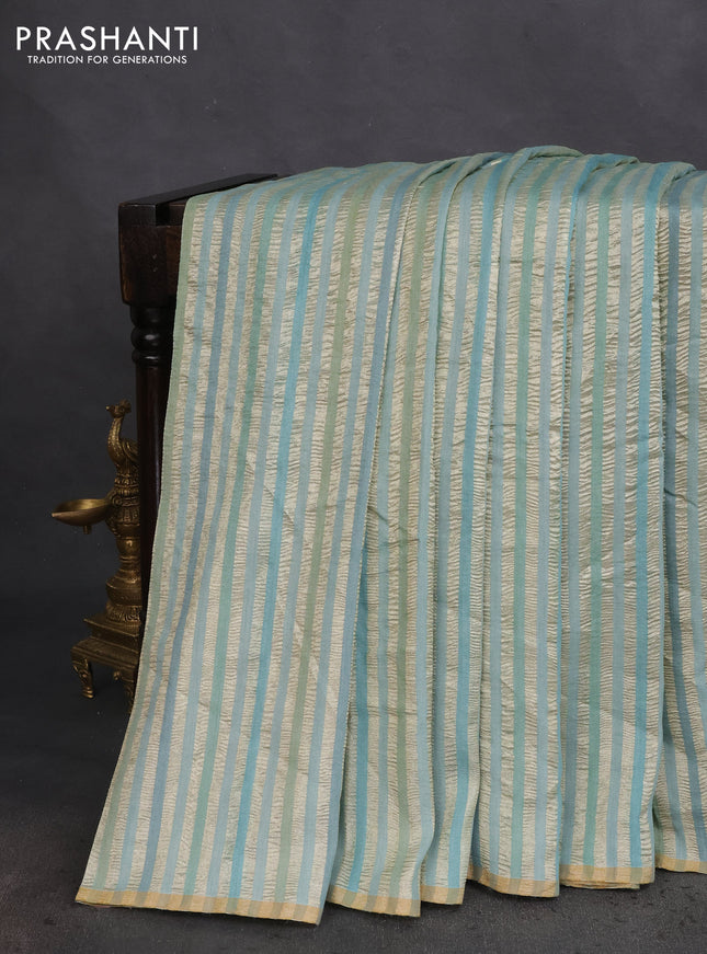 Munga silk saree pastel blue with allover zari woven stripes pattern in borderless style