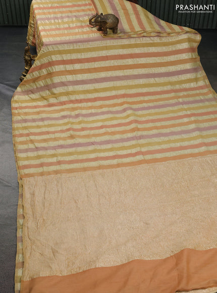 Munga silk saree pale yellow and pale orange with allover zari woven stripes pattern in borderless style