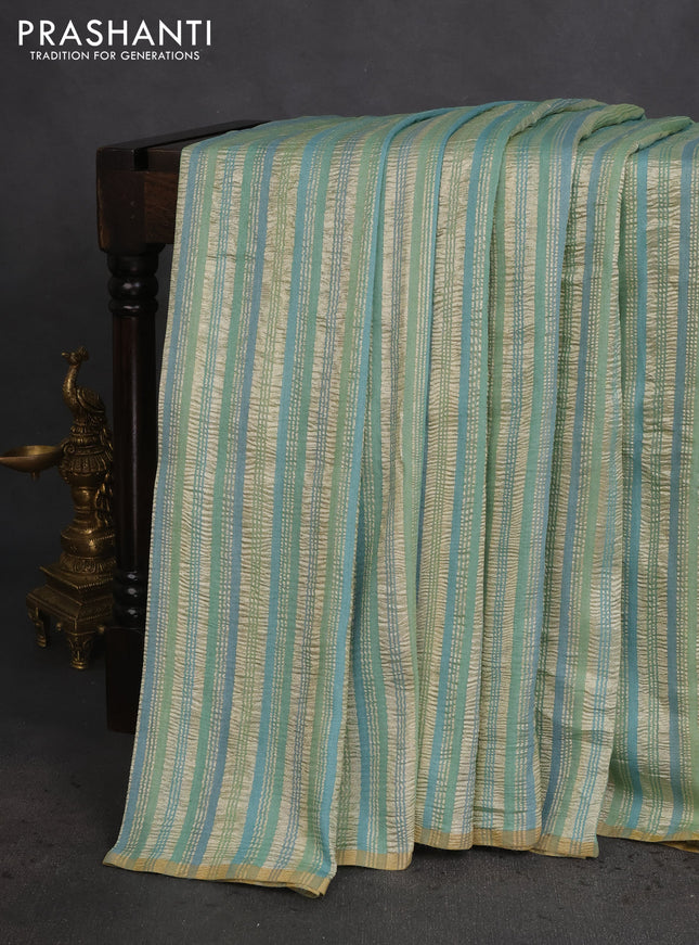 Munga silk saree pastel green and pastel blue with allover zari woven stripes pattern in borderless style