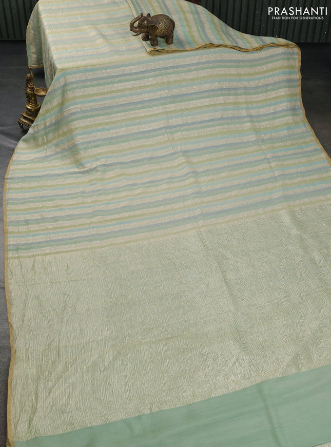 Munga silk saree pastel green and pastel blue with allover zari woven stripes pattern in borderless style