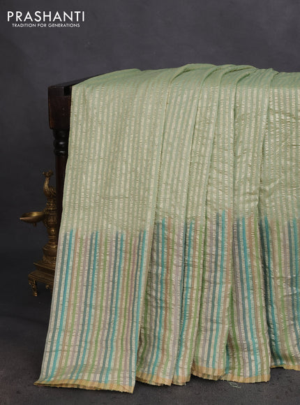 Munga silk saree pastel green with allover zari woven stripes pattern in borderless style