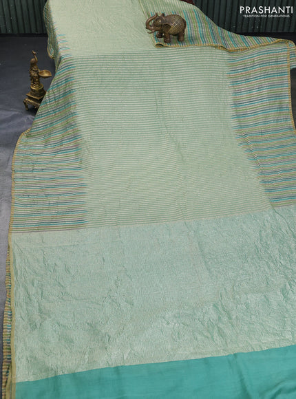 Munga silk saree pastel green with allover zari woven stripes pattern in borderless style