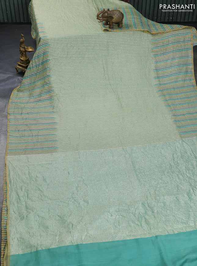Munga silk saree pastel green with allover zari woven stripes pattern in borderless style