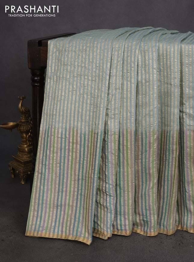 Munga silk saree pastel blue with allover zari woven stripes pattern in borderless style