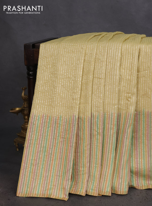 Munga silk saree pale yellow with allover zari woven stripes pattern in borderless style