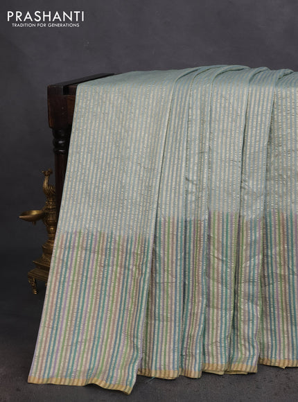 Munga silk saree pastel blue with allover zari woven stripes pattern in borderless style