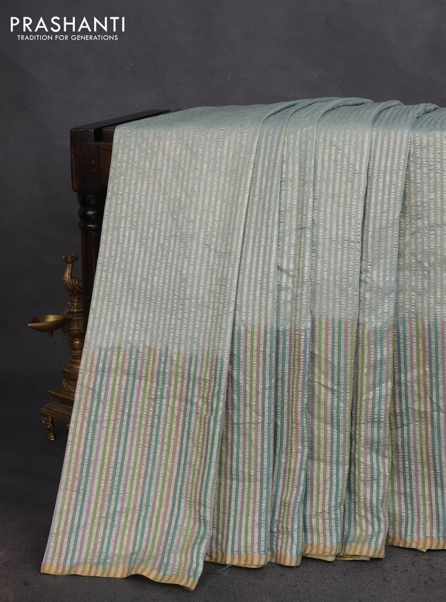 Munga silk saree pastel blue with allover zari woven stripes pattern in borderless style
