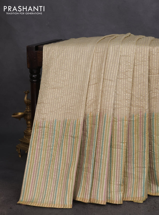 Munga silk saree beige with allover zari woven stripes pattern in borderless style
