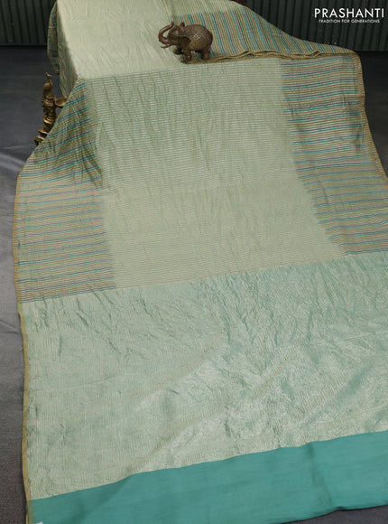 Munga silk saree pastel green with allover zari woven stripes pattern in borderless style