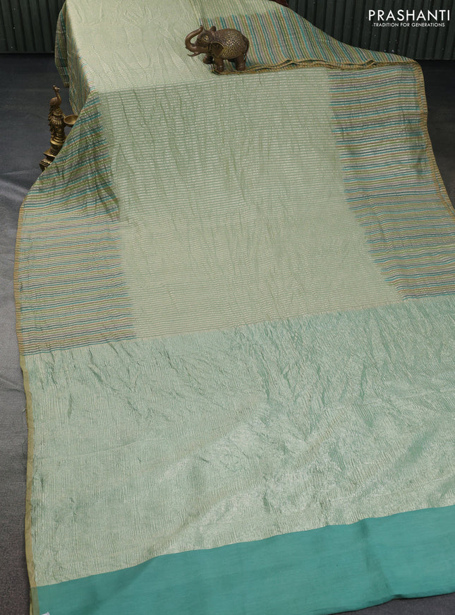 Munga silk saree pastel green with allover zari woven stripes pattern in borderless style