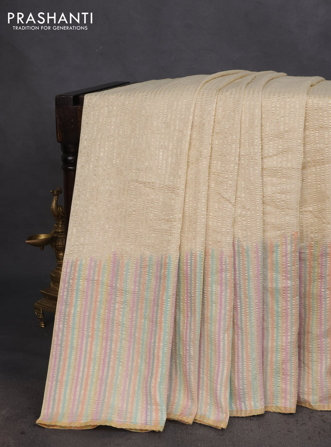 Munga silk saree cream with allover zari woven stripes pattern in borderless style