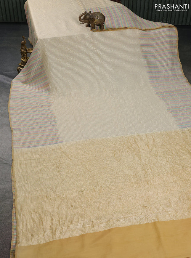 Munga silk saree cream with allover zari woven stripes pattern in borderless style