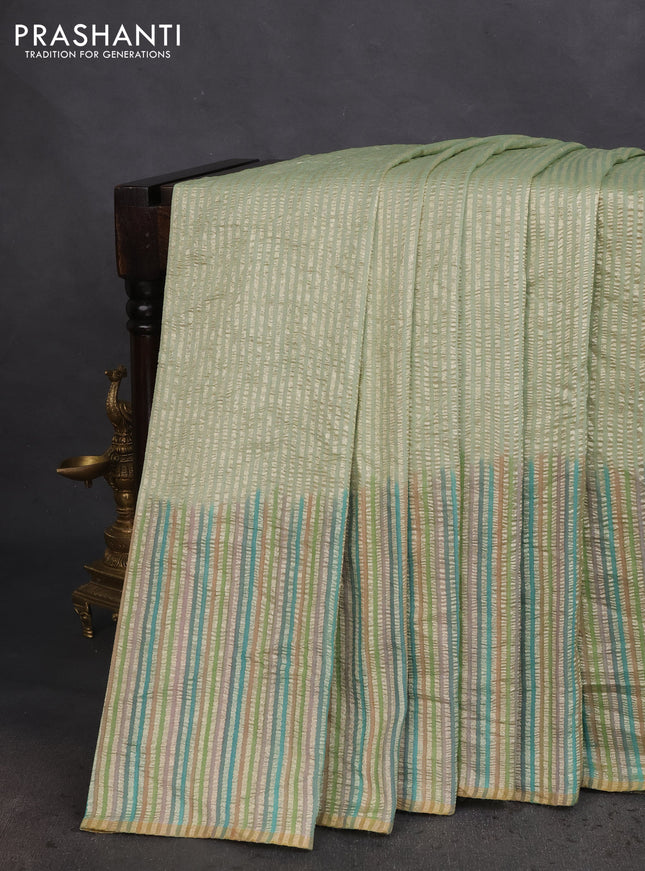 Munga silk saree pastel green with allover zari woven stripes pattern in borderless style