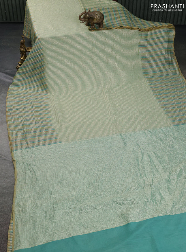 Munga silk saree pastel green with allover zari woven stripes pattern in borderless style