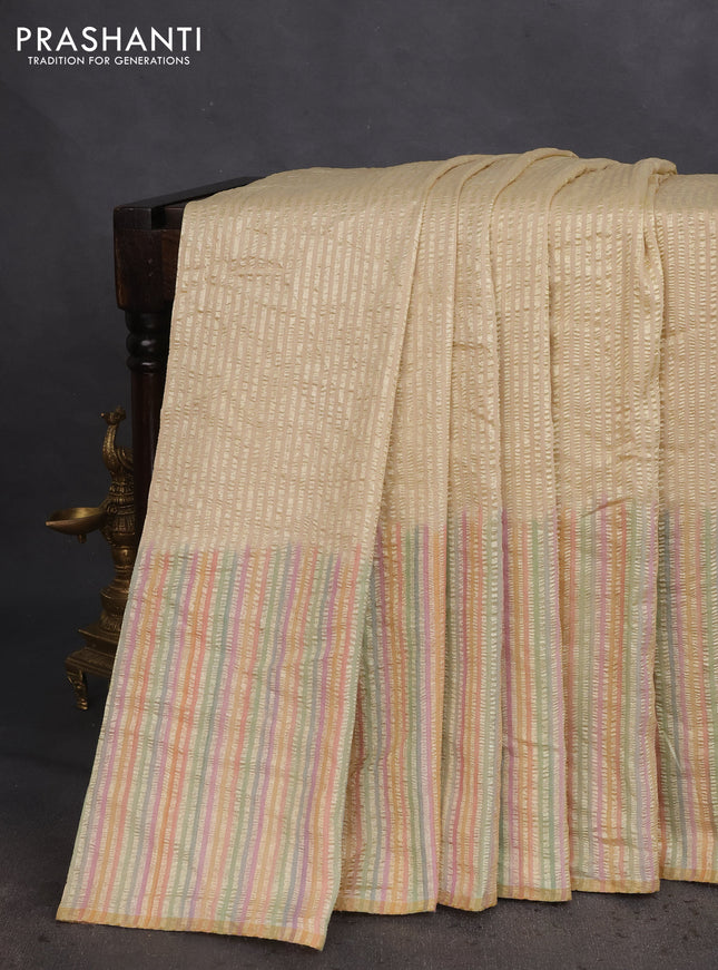 Munga silk saree cream and multi colour with allover zari woven stripes pattern in borderless style