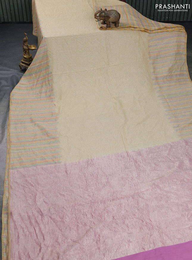Munga silk saree cream and multi colour with allover zari woven stripes pattern in borderless style