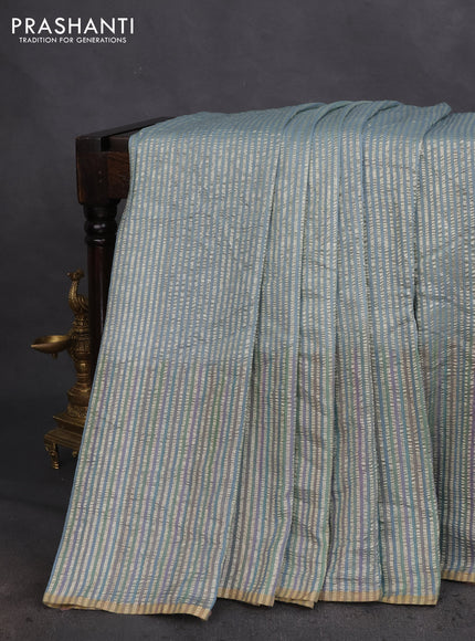 Munga silk saree pastel blue with allover zari woven stripes pattern in borderless style