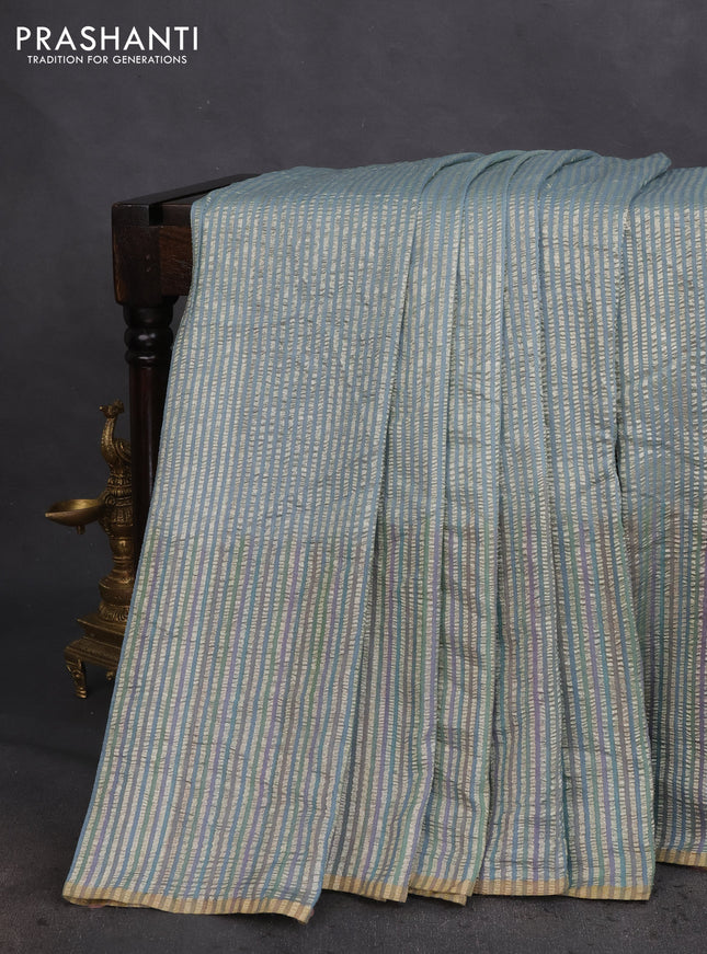 Munga silk saree pastel blue with allover zari woven stripes pattern in borderless style