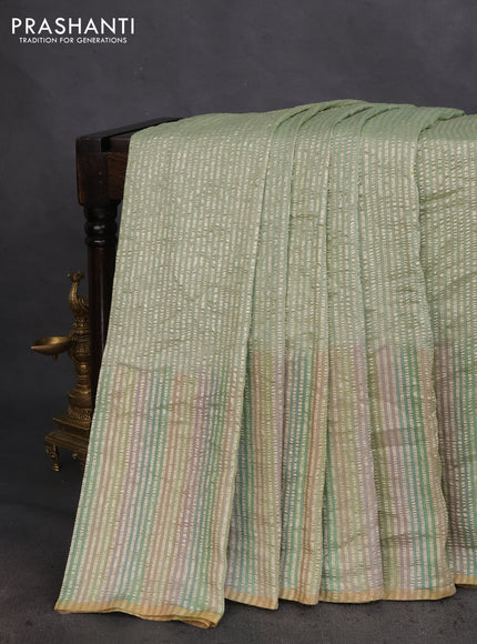 Munga silk saree pastel green and multi colour with allover zari woven stripes pattern in borderless style
