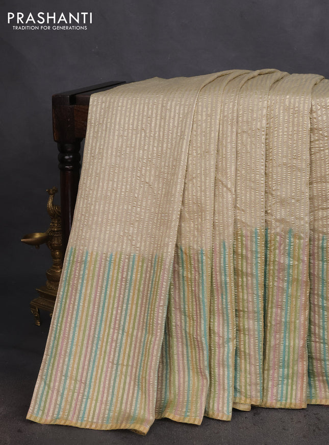 Munga silk saree beige and multi colour with allover zari woven stripes pattern in borderless style