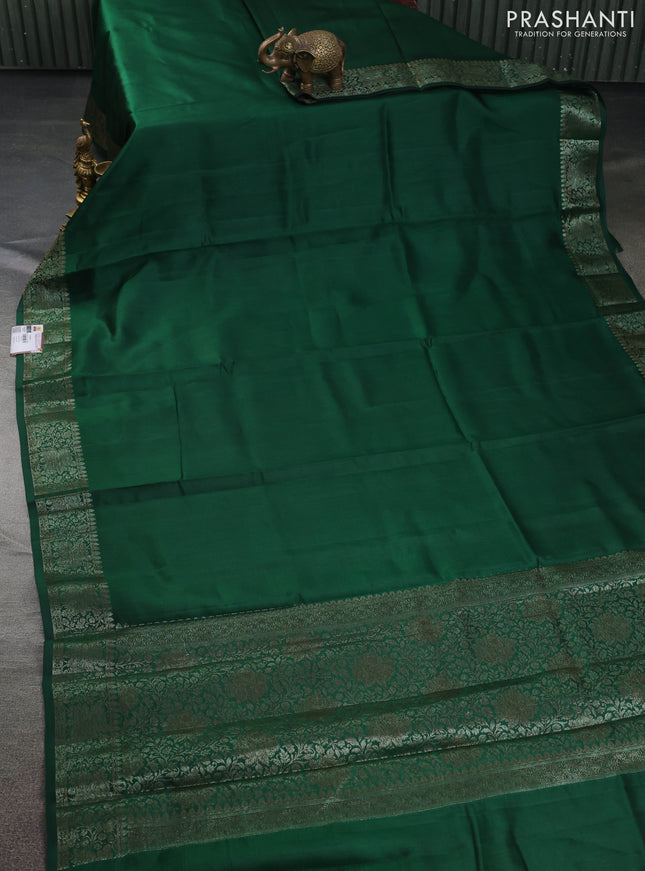 Chiniya silk saree dark green and rust shade with plain body and woven border
