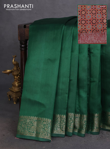 Chiniya silk saree dark green and rust shade with plain body and woven border