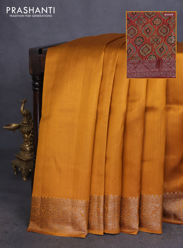 Chiniya silk saree dark mustard and rust shade with plain body and woven border