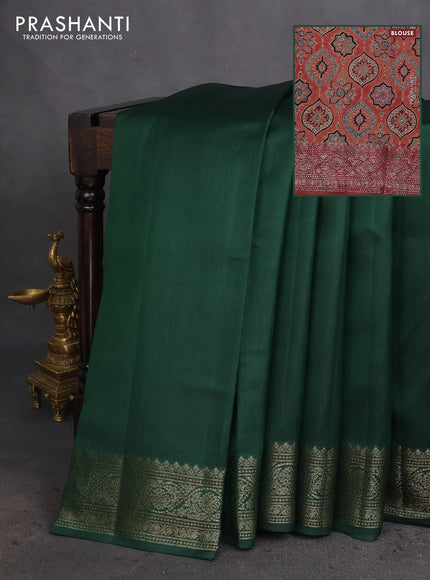 Chiniya silk saree dark green and rust shade with plain body and woven border