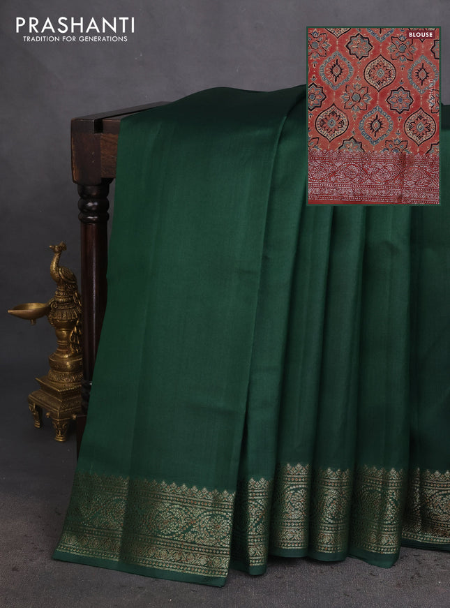 Chiniya silk saree dark green and rust shade with plain body and woven border