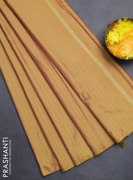 Arani semi silk saree dual shade of mustard with allover silver zari weaves in borderless style