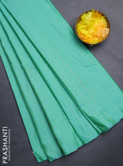 Arani semi silk saree teal green with allover zari weaves in borderless style