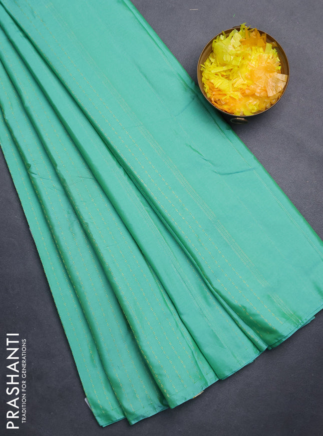 Arani semi silk saree teal green with allover zari weaves in borderless style