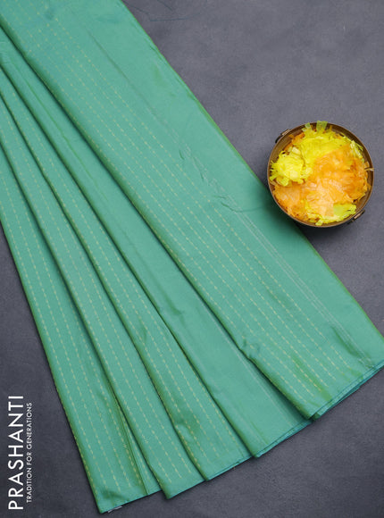 Arani semi silk saree teal green with allover zari weaves in borderless style
