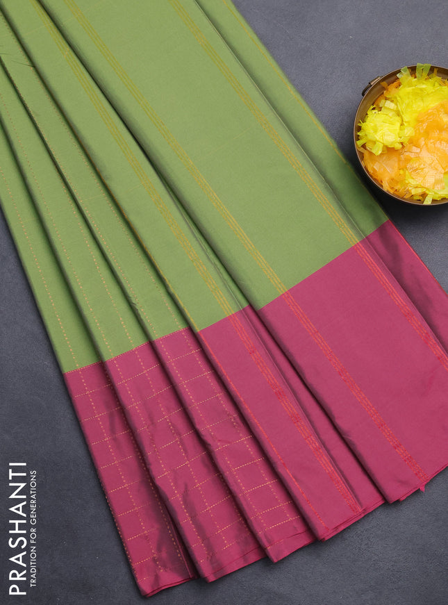 Arani semi silk saree green and magenta pink with allover copper zari weaves and zari checked border
