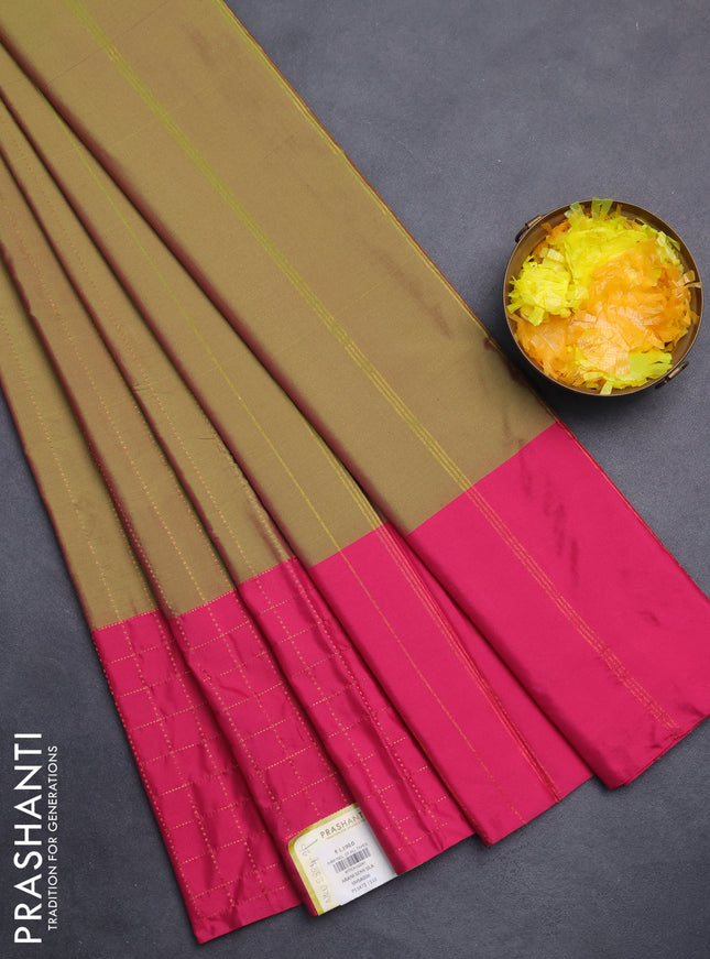 Arani semi silk saree dual shade of green and pink with allover copper zari weaves and zari checked border