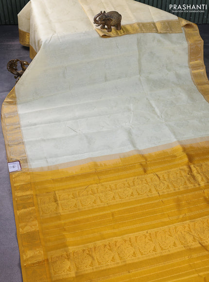 Silk cotton saree cream and mustard yellow with allover self emboss jacquard and annam zari woven border