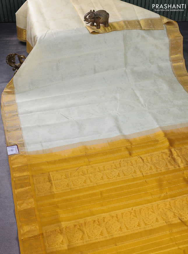 Silk cotton saree cream and mustard yellow with allover self emboss jacquard and annam zari woven border