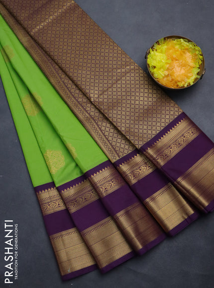 Semi kanchipuram silk saree green and purple with zari woven buttas and long rettapet zari woven korvai border