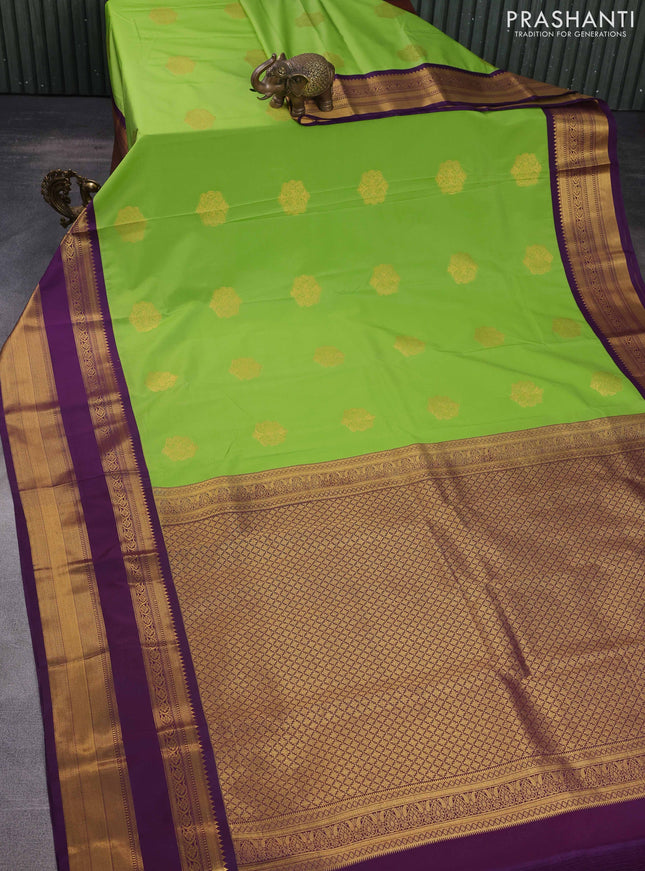 Semi kanchipuram silk saree green and purple with zari woven buttas and long rettapet zari woven korvai border
