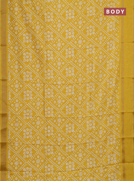Semi dola saree yellow with allover bandhani prints and zari woven border