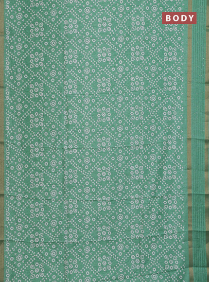Semi dola saree pastel green with allover bandhani prints and zari woven border