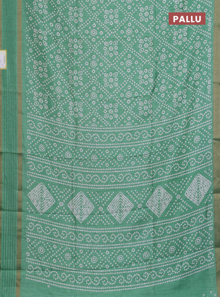 Semi dola saree pastel green with allover bandhani prints and zari woven border