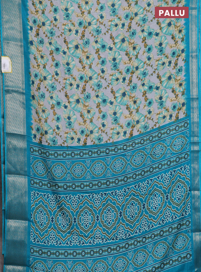 Semi dola saree grey and teal blue with allover floral prints and zari woven border