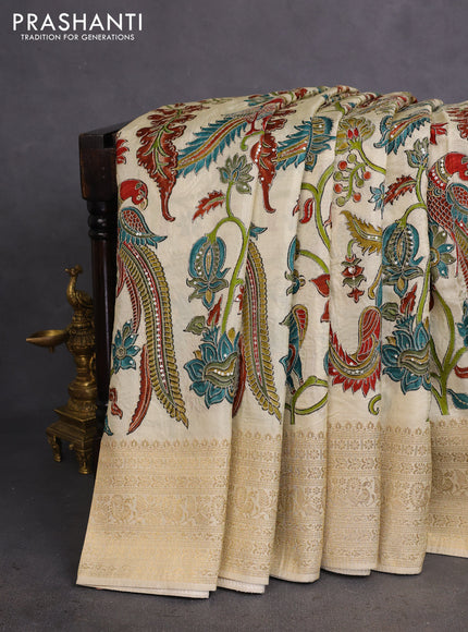 Crepe silk saree cream with allover kalamkari prints & embroidery work and zari woven border
