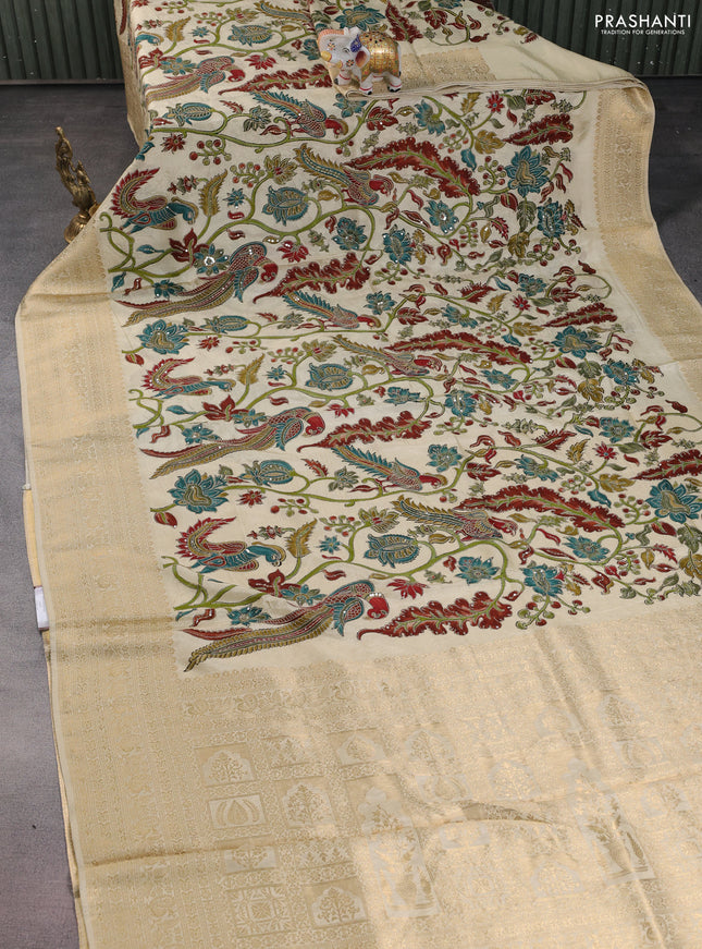 Crepe silk saree cream with allover kalamkari prints & embroidery work and zari woven border