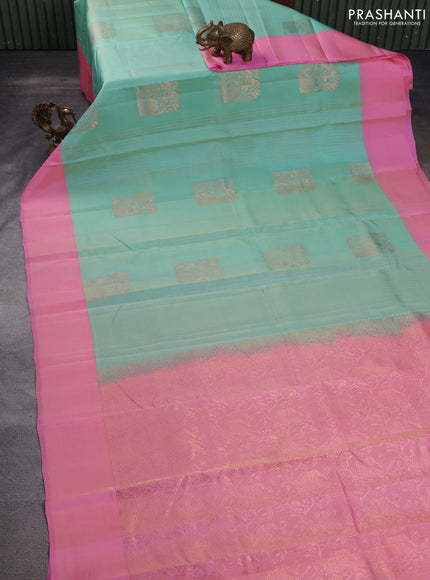 Kanchipuram silk saree dual shade of teal blue and light pink with allover copper zari weaves and simple border