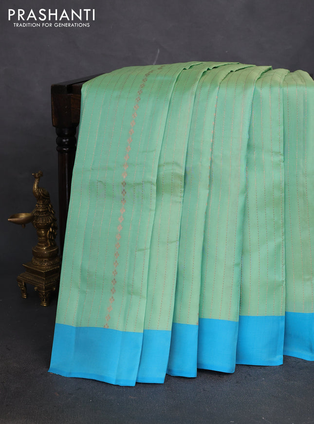 Kanchipuram silk saree teal green shade and blue with allover copper zari weaves and simple border